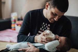 Father giving baby a bottle
