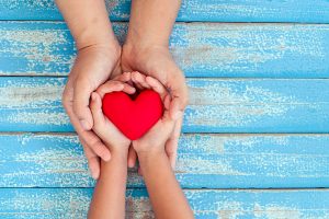 Hands holding red heart