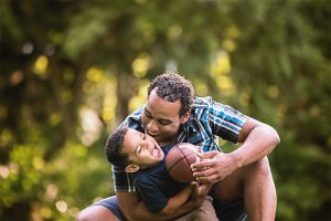 Father and son playing football