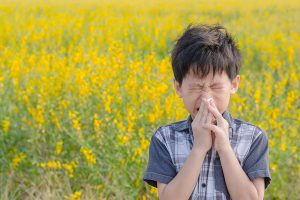 Boy sneezing from allergies. how to beat springtime allergies in kids!
