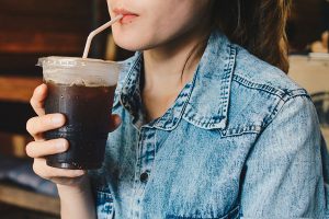 Teen girl drinking iced coffee