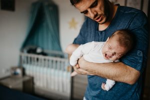 Father holding colicky baby