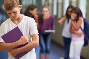 A young boy being bullied at school