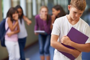 A young boy being bullied at school